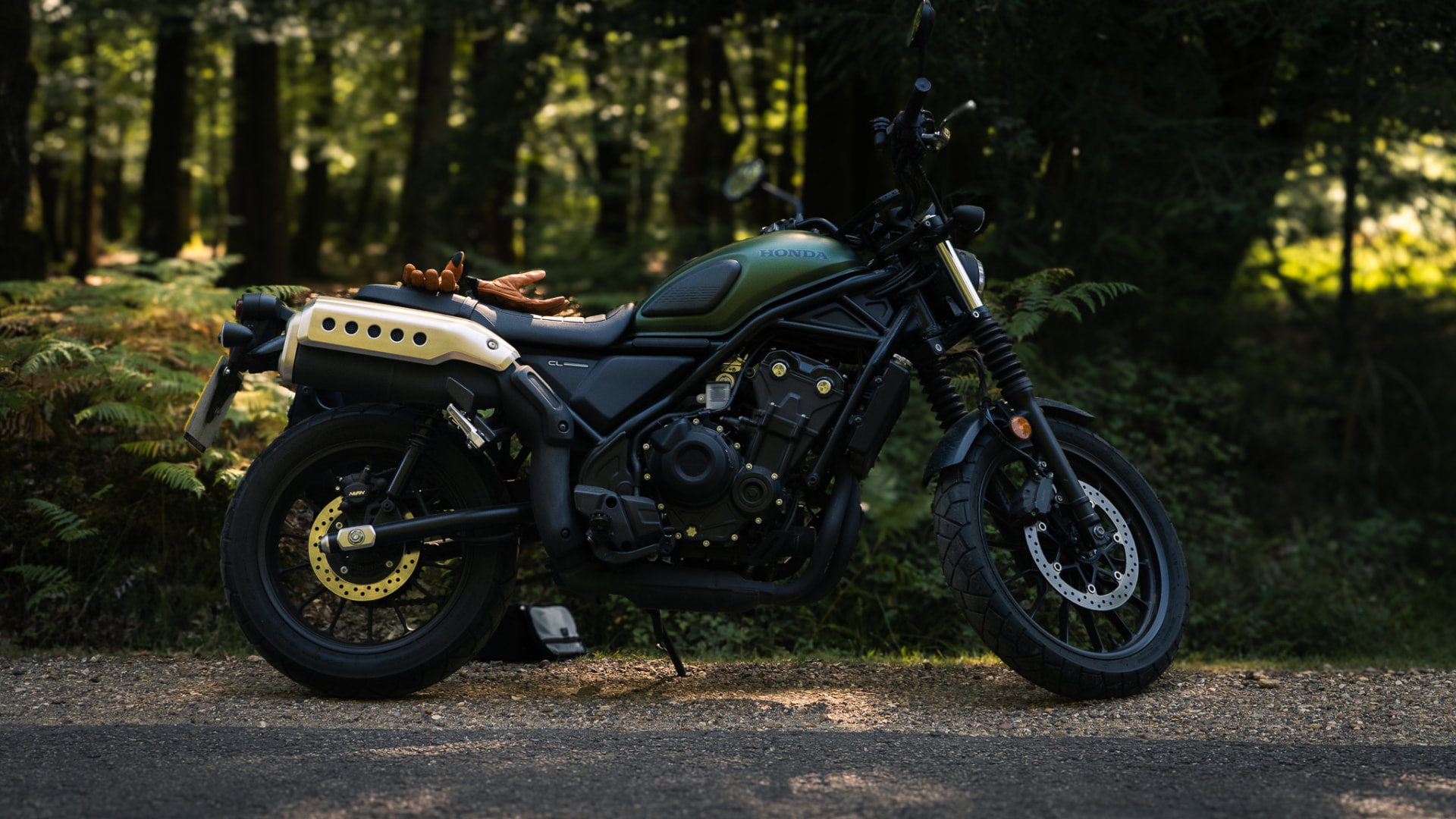 A motorcycle on an empty road winding through open country