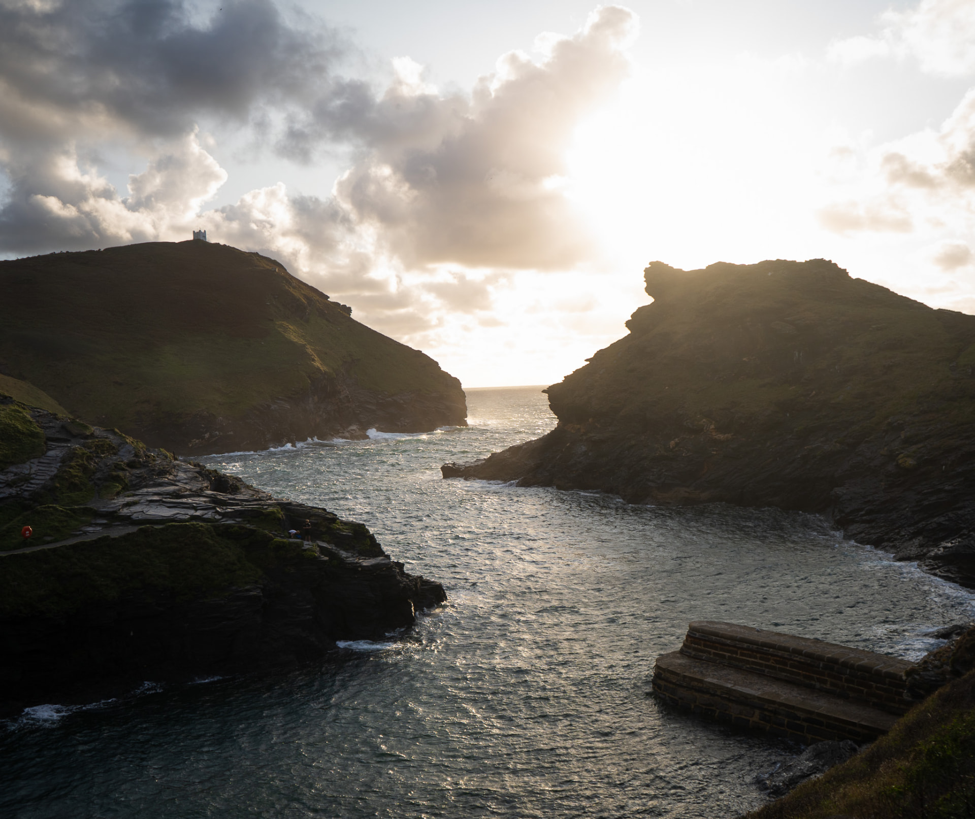 The harbour entrance at Boscastle, framed by headlands in low evening light