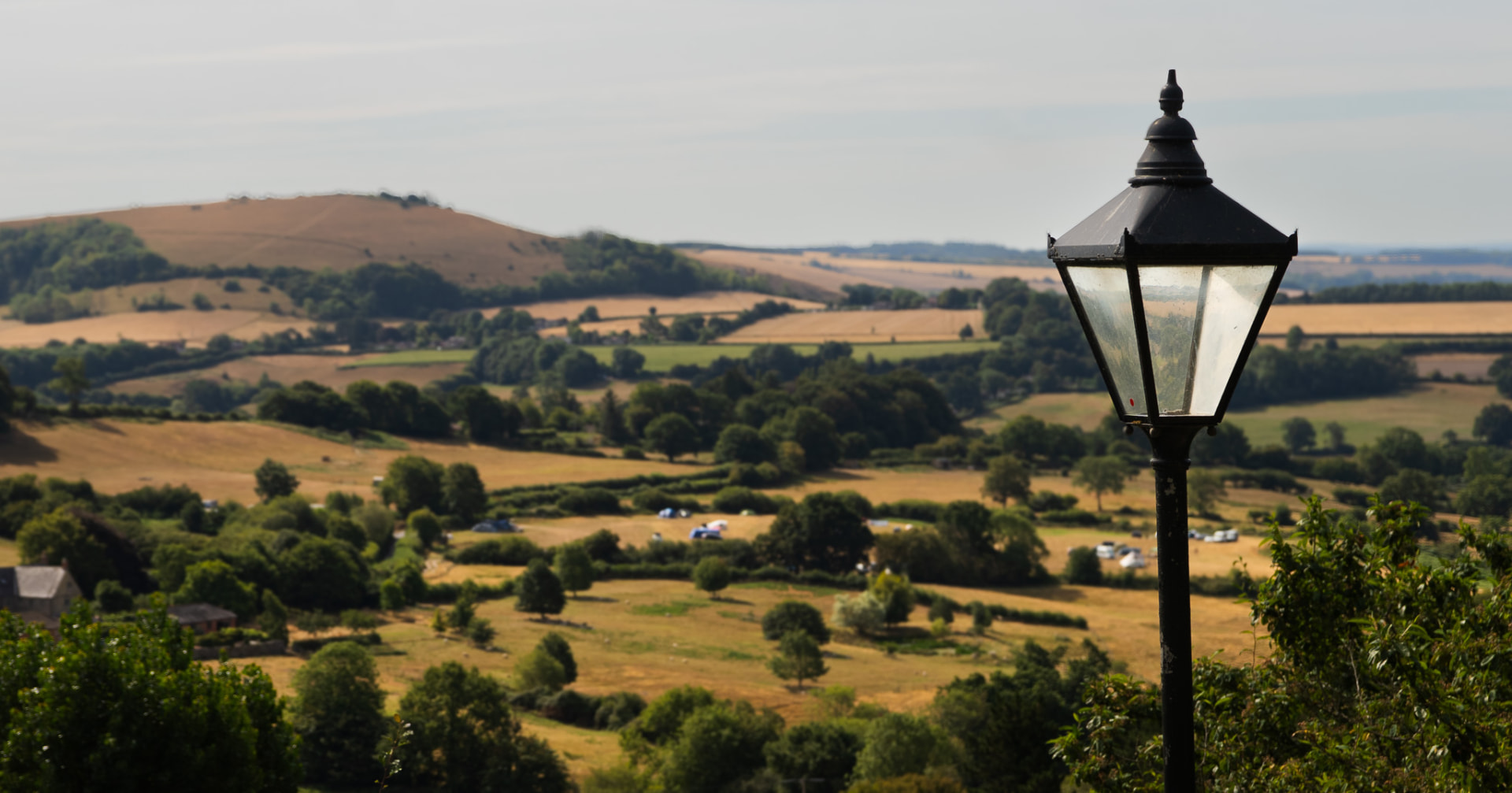 A cast iron lamppost above a patchwork of Dorset fields and hills.